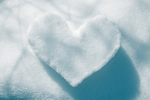 Heart shape drawn in snow a sunny winters day