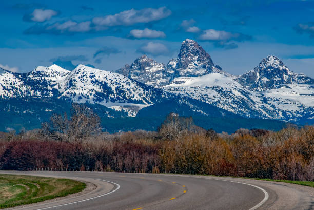 Teton peaks from the back side, looking east from Idaho on the highway to Jackson Hole, Wyoming - the Grand Teton Nation Park's peak viewed from Idaho are just as spectacular as from the other side. This is Idaho of the United States of America (USA).