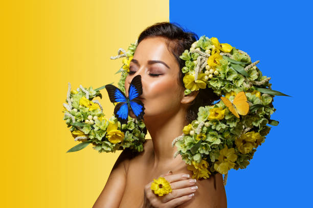 Studio portrait of a beautiful brunette Flower Queen wearing a unique headpiece with Ukrainian colours