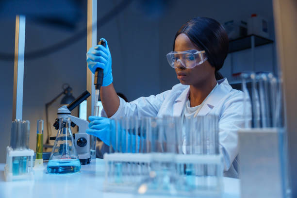 istock A young beautiful concentrated microbiologist in protective glasses in a modern laboratory, working with micropipette at her table with laboratory flasks and glass test tubes in a test tube rack 1390303373