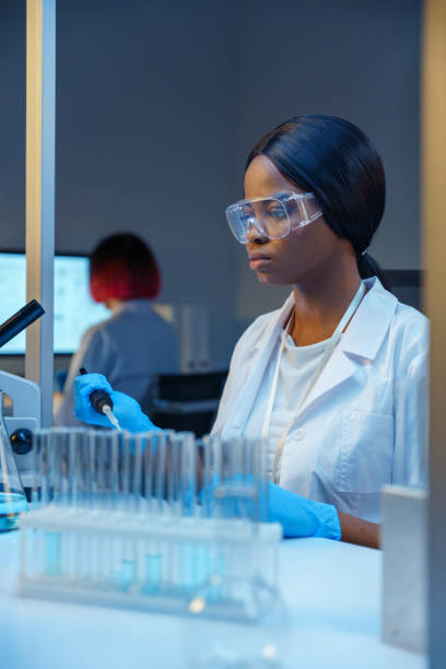 istock A young beautiful African-American lab assistant in protective glasses at work in a modern laboratory 1390303375