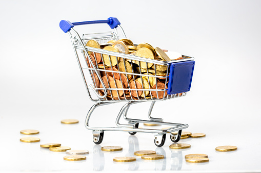 Shopping cart and European union currency coins
