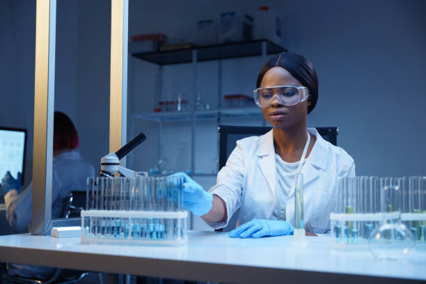 istock A student in a white lab coat working in a modern laboratory, we see her in a professional light 1390303462