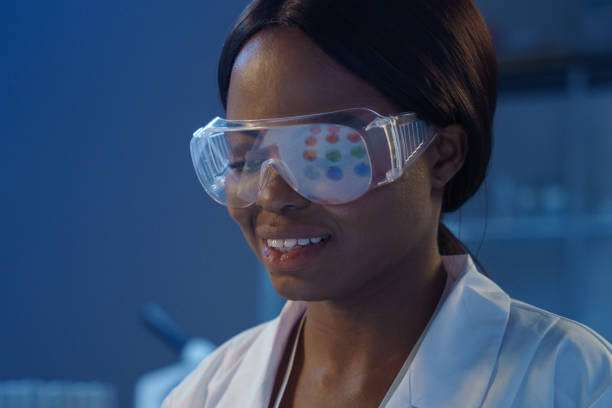 istock A close -up of a young smiling beautiful scientist in protective eyewear on a blurred background in a modern laboratory 1390304529