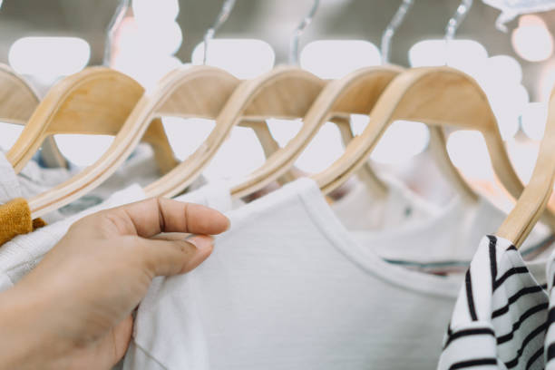 istock Woman's hands shopping for shirts, clothes shopping concept. 1390306202