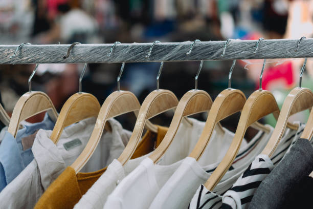istock women clothes hanging on clothing rack. 1390306224