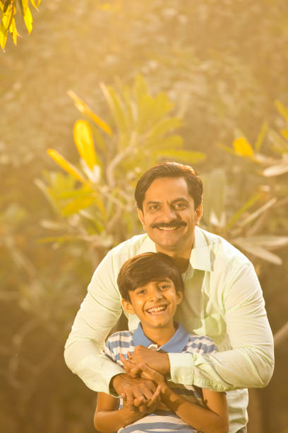 istock Cheerful boy admiring nature with his father 1390307443