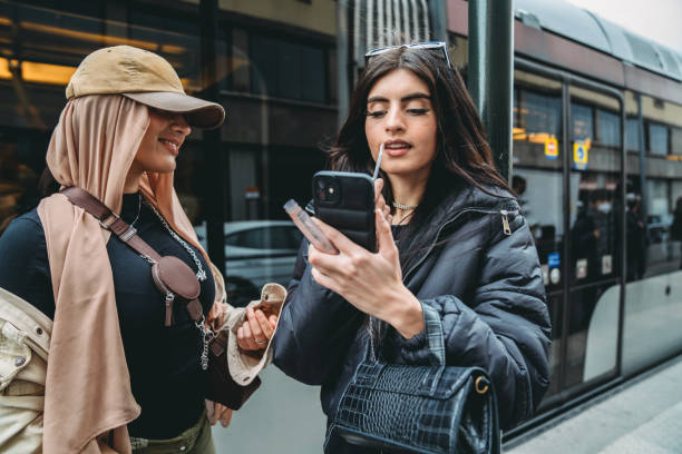 istock A young adult woman is doing her makeup using the phone as a mirror 1390307621