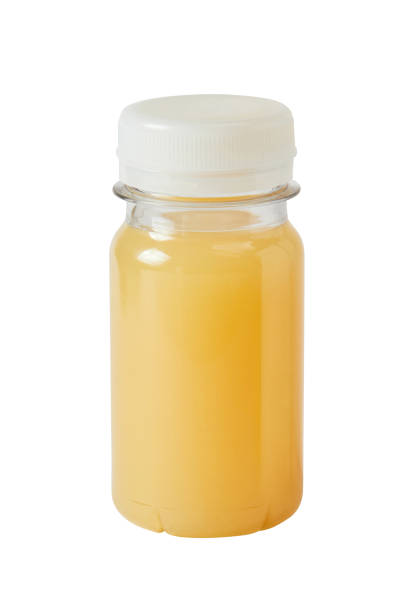 istock Small plastic PET bottle with orange juice isolated 1390309085