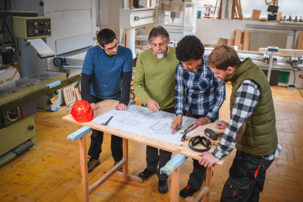 istock Diverse Group of Carpenters Working On A Plan 1390310450