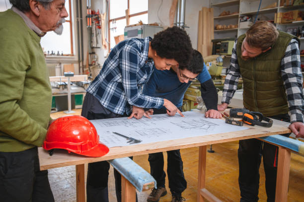 istock Small Group Of Carpenters Discussing New Project 1390310462