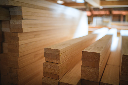 Close up of stacks of lumber being stored in a warehouse