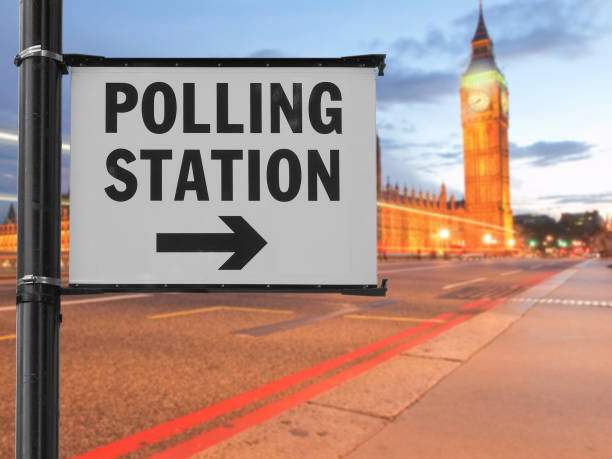 istock polling station sign over blurred parliament background 1390316041