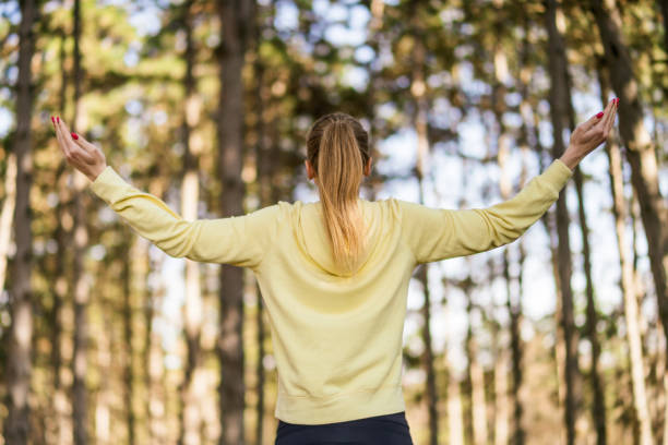 istock Sporty woman with arms outstretched 1390318606
