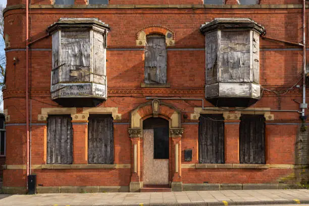Exterior of old abandoned building in English city.