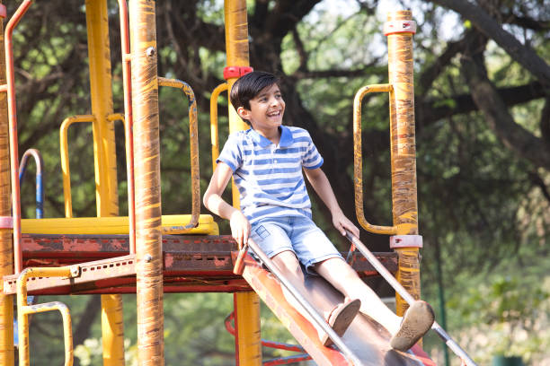 istock Boy having fun on slide at playground 1390321016