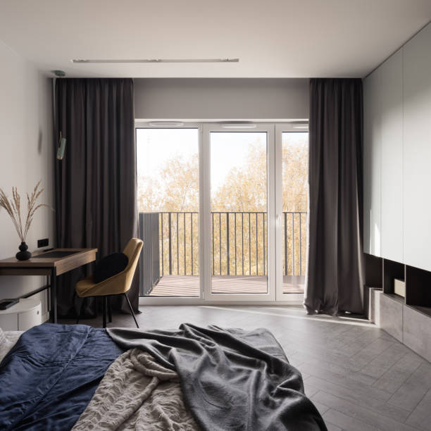istock Big window in bedroom with desk 1390323414