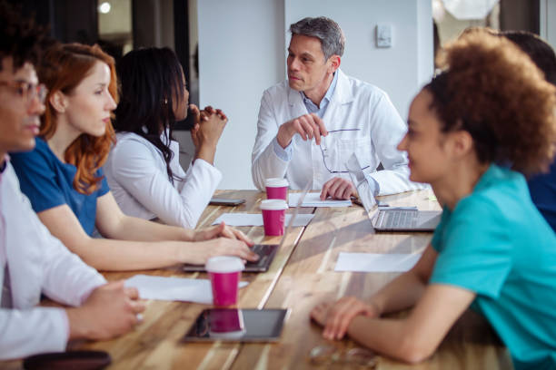 istock A diverse group of doctors drink disposable coffee cups during a coffee break. 1390325911