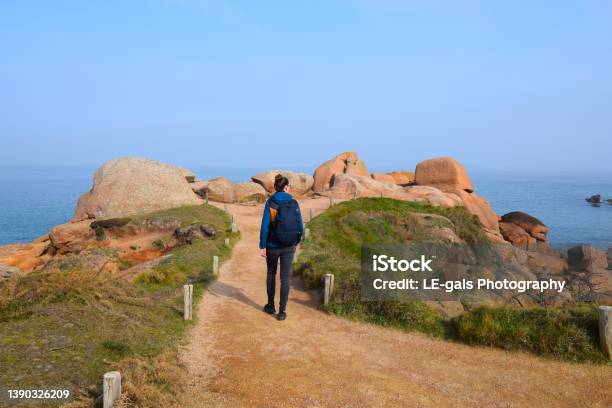 Young Woman Hiking Trail On Cote Granite Rose In Brittany France Stock Photo - Download Image Now