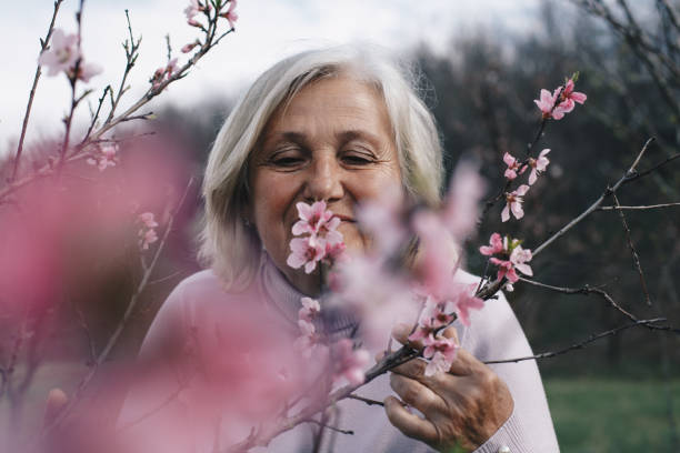 istock Senior woman walking outside in spring nature 1390326211