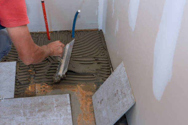 istock Process laying floor ceramic tiles, application of the adhesive base 1390326471