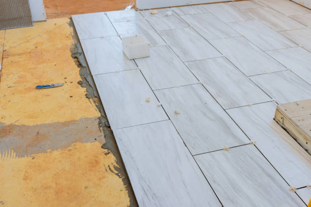 istock The process of laying ceramic tiles on glue smeared floors 1390326497