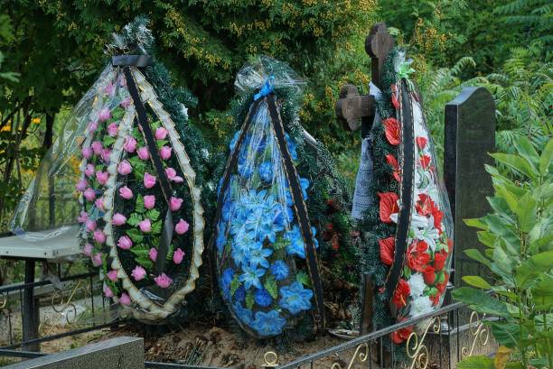 istock three colored funeral wreaths on a grave 1390326508