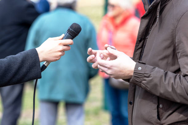 istock News reporter making media or vox pop interview with unrecognizable person 1390329081