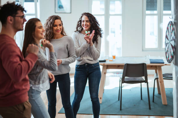 istock Young friends playing darts together. 1390329176