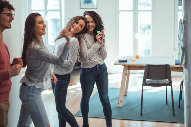 istock Young friends playing darts together. 1390329188