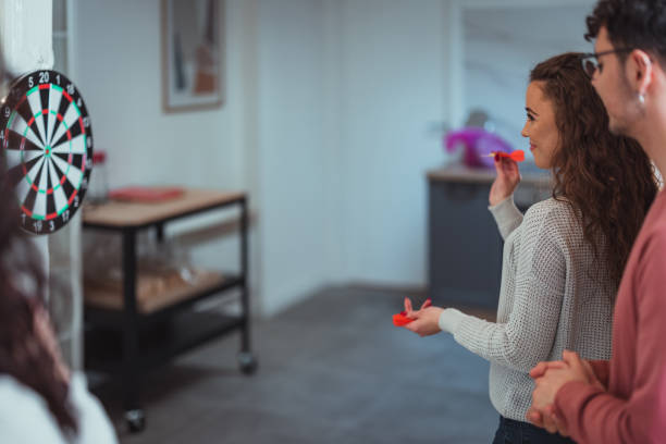 istock Young friends playing darts together. 1390329194