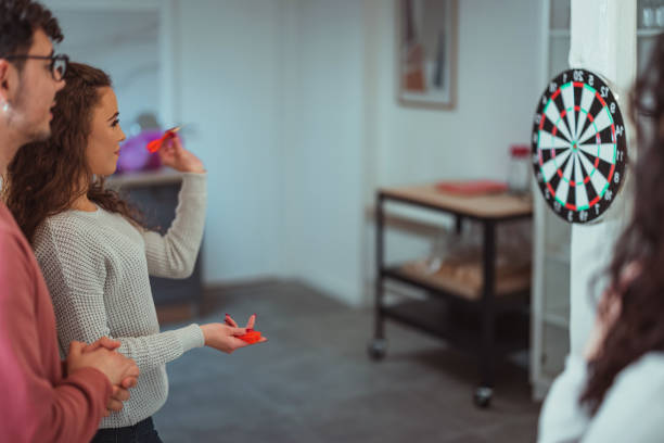 istock Young friends playing darts together. 1390329205