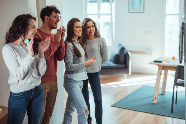 istock Young friends playing darts together. 1390329211
