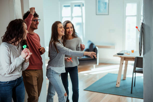 istock Young friends playing darts together. 1390329231