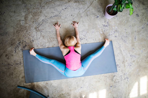 istock Young woman practicing yoga in yoga studio 1390330428