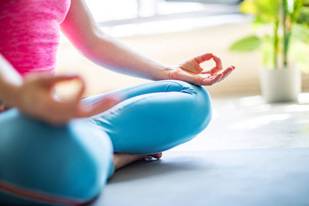 istock Young woman practicing yoga at home 1390330439