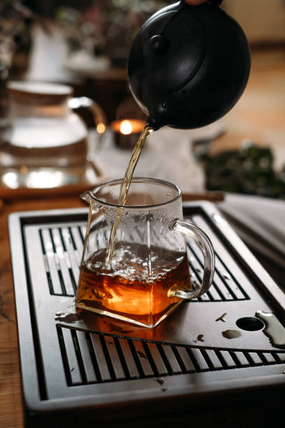 istock Traditional tea ceremony - pouring chinese oolong in glass cup 1390330792