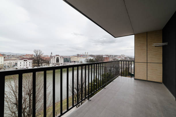 balkon mit schwarzem metallgeländer. blick auf die stadt - balaustrade stock-fotos und bilder