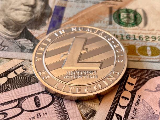 Litecoin Litecoin on U.S Currency investments Background. Digital currency used for verified transactions while  maintaining a digital record in  a decentralized system using cryptography, rather than by a centralized authority. litecoin stock pictures, royalty-free photos & images