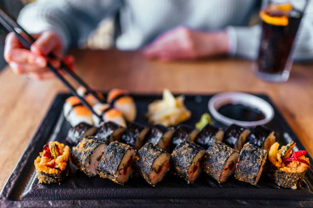 istock Eating sushi with chopsticks at sushi restaurant 1390334830