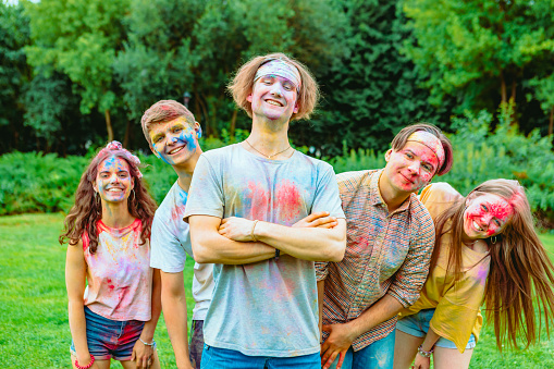 young happy friends at holi fest indian traditional holiday