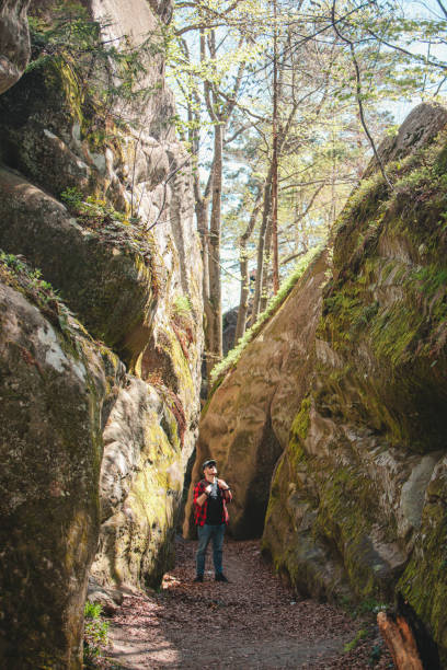 istock man hiker with backpack walking by trail in canyon 1390335079