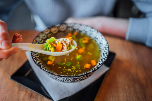 istock Woman eating a soup at restaurant 1390335087