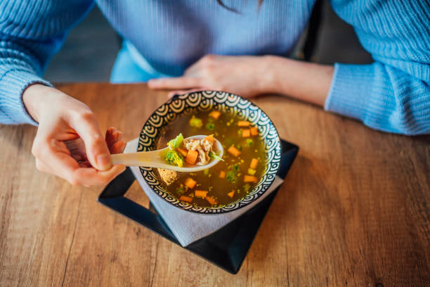 istock Woman eating a soup at restaurant 1390335377