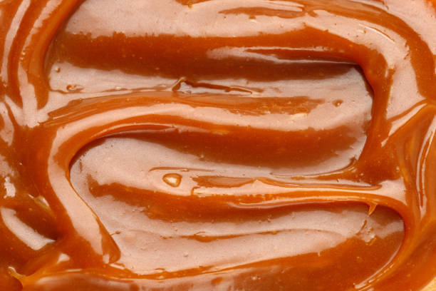 istock Liquid caramel syrup. Background of caramel paste. Texture Close up, top view. 1390337591