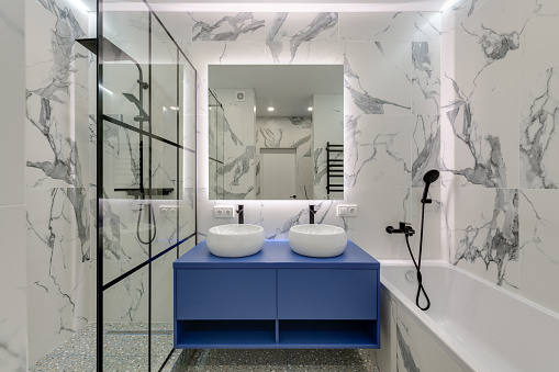 Modern bright bathroom with washbasins and large mirror with sub-heading. High quality photo