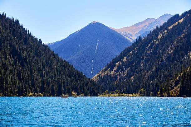 istock view of a mountain lake surrounded by forest 1390337668