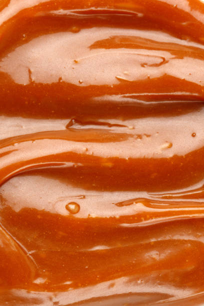 istock Liquid caramel syrup. Background of caramel paste. Texture Close up, top view. 1390337754