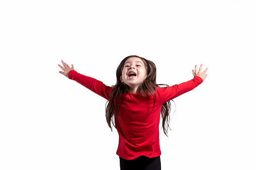 Portrait of happy little girl jumping on white background. Horizontal composition. Studio shot.