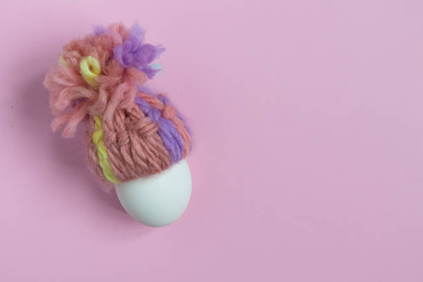 istock Easter egg in a hat on a lilac background with a place for text. Holiday. 1390342564